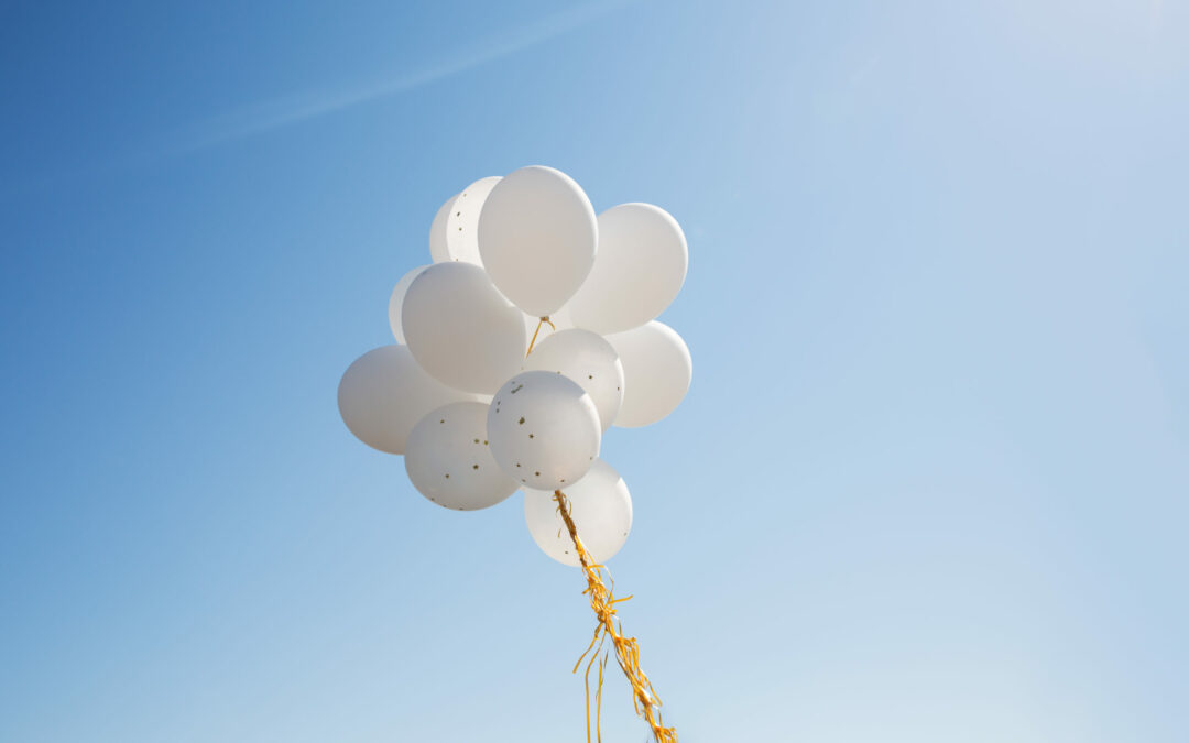 holidays birthday party decoration concept close up inflated white helium balloons blue sky scaled
