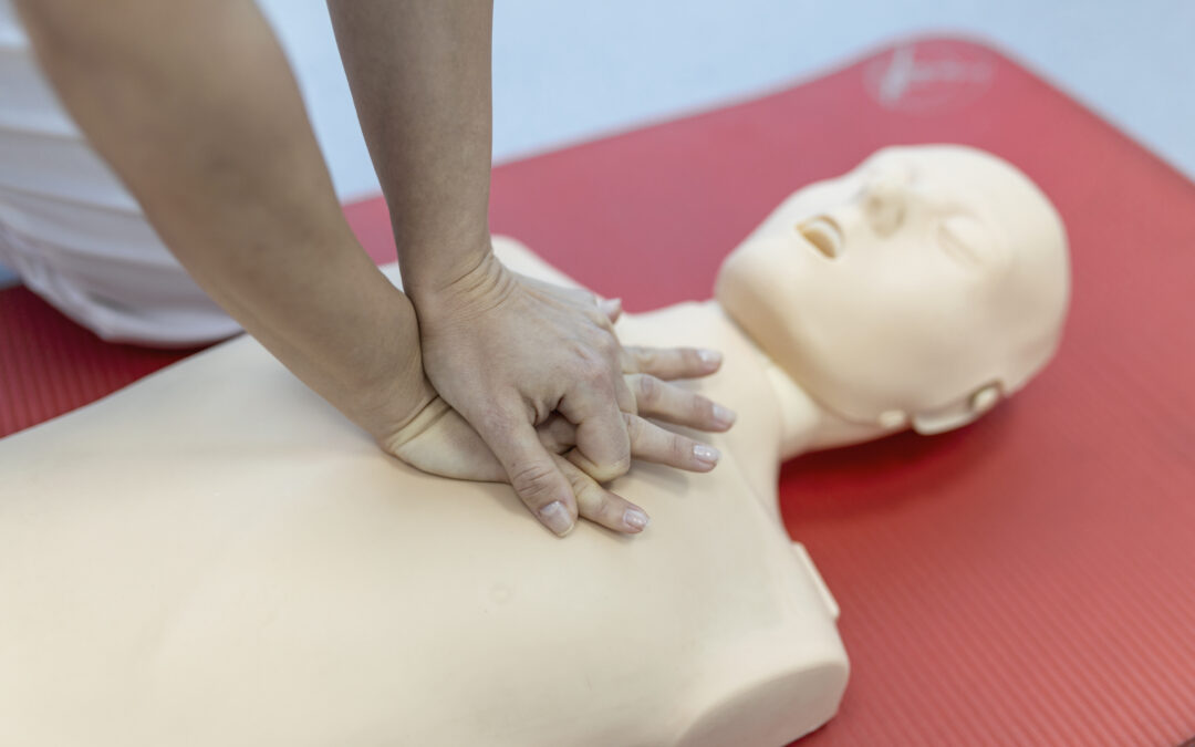 cpr class with instructors talking demonstrating firt aid compressions ans reanimation procedure cpr dummy scaled