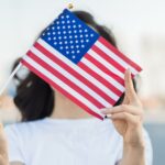 portrait woman holding usa flag face scaled