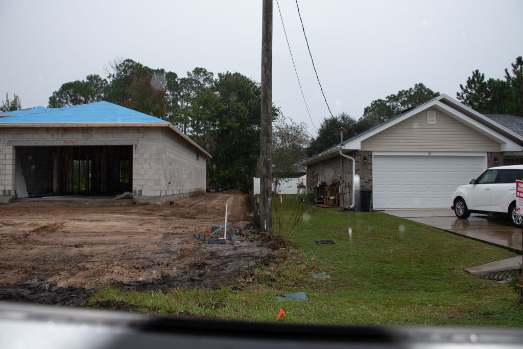DS street view between two houses, one built higher than the other.