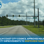 A traffic signal stands over an empty intersection on a wide road with trees in the background Text reads: "Palm Coast City Council approves major safety improvements to Whiteview Parkway
