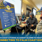 People visit an informational booth about water conservation at an indoor expo A display board shares tips on saving water Several attendees interact with the booth, gathering materials and talking with presenters