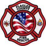 A badge shaped logo with "Flagler County Fire Rescue" text, featuring a waving American flag in the center, firefighting symbols on the left, and a fire/EMS symbol on the right, all outlined in red and black