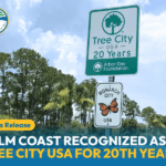Roadside signs surrounded by palm trees read "Tree City USA Years" and "Monarch City USA " Text overlay announces Palm Coast recognized as Tree City USA for the th year Arbor Day Foundation logo is visible