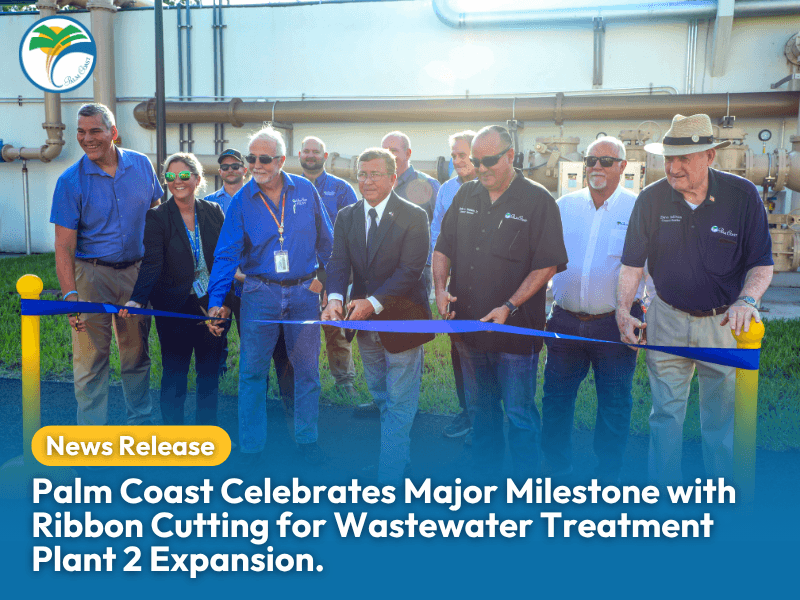 A group of people, including officials, smile as they cut a blue ribbon outside an industrial facility for the Palm Coast Wastewater Treatment Plant expansion A "News Release" banner and headline text are overlaid at the bottom