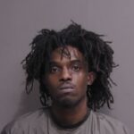 A man with dreadlocks looking at the camera