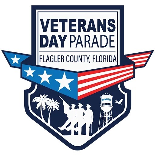 A badge shaped logo for the Veterans Day Parade in Flagler County, Florida, featuring stars, a waving American flag, silhouettes of soldiers, palm trees, a water tower labeled "Bunnell," and an airplane