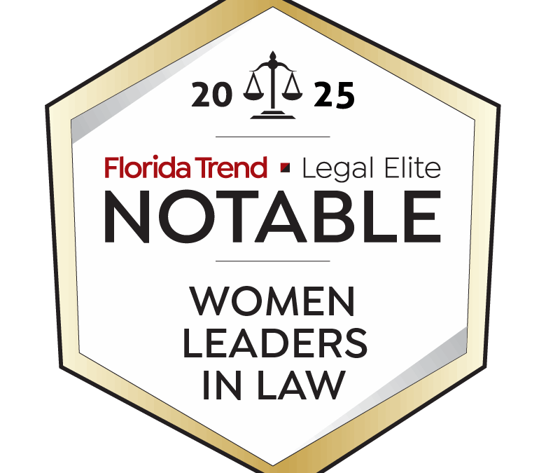 Hexagonal badge with a gold border showing the text “ Florida Trend Legal Elite Notable Women Leaders in Law,” along with a scale of justice icon at the top