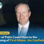 A man in a suit and tie smiles at the camera Text reads: “City of Palm Coast Mourns the Passing of First Mayor Jim Canfield ” A Palm Coast logo appears in the top left corner