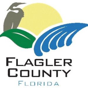 Logo for Flagler County, Florida, featuring a heron, green leaf, blue waves, and a yellow sun "Flagler County Florida" is displayed below in black and light blue text This design reflects the vibrant spirit of Flagler County