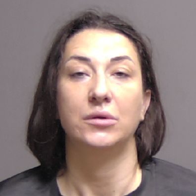 A headshot of a woman with dark hair against a plain background
